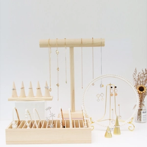 Macro view of minimalist wooden jewelry stands for necklaces rings and earrings
