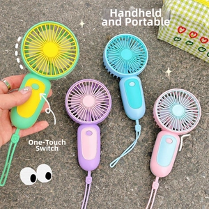Detail of four macaron-colored portable handheld USB fans with lanyards and power buttons