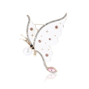 Exquisite gold butterfly brooch with rhinestones, white wings and pink gemstone drop
