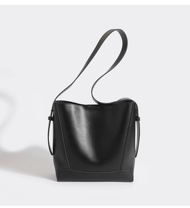 Detail view of the black leather bucket bag with wide shoulder strap and stitch bottom