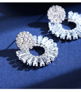 Macro detail of silver studs featuring radial marquise and round cut brilliant zircons