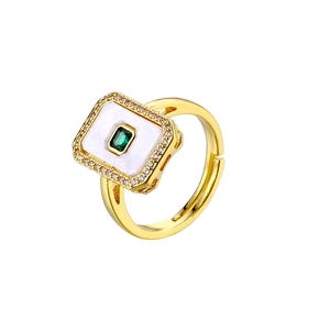 Detail of square emerald gemstone ring with diamond halo and 18K gold plated band