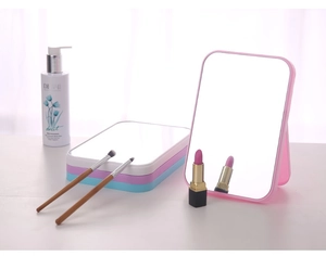 Detail of colorful portable makeup mirrors with foldable stands in pastel shades