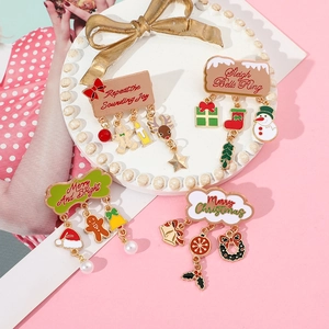 Detail view of 4 Christmas alloy brooches with bells, snowflakes and faux pearls