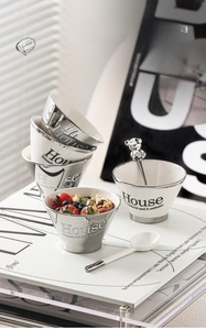Detail of luxury ceramic bowl with silver plating and metal bear spoon gift set