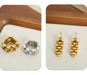 Macro detail of gold and silver chain link style rings and stud earrings on tray