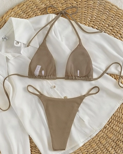 Detailed flat lay of brown ribbed halter bikini set with tie-up straps and high-quality texture