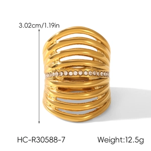 Macro detail of wide 18k gold plated hollow layered ring with white crystal stones