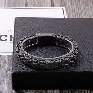 Macro shot of 316L stainless steel engraving on a punk style dragon bone bracelet