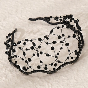 Detail of handcrafted black beaded bridal headband with woven mesh and crystal rhinestones