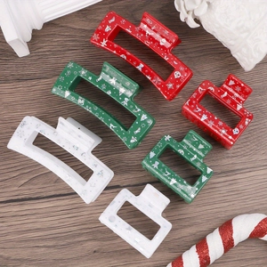 Christmas hair claws with festive cartoon patterns in red, green, and white colors