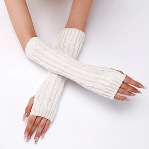 Detail of cream cable knit fingerless gloves showing long textured arm warmers on model