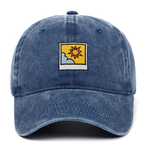 Blue washed denim baseball cap featuring a creative sun and cloud embroidery patch