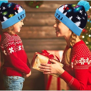 Festive blue LED knit Christmas hat featuring snowman and snowflake patterns for winter