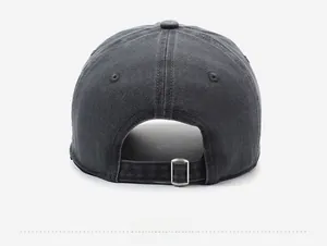 Close-up of vintage washed cotton baseball cap with adjustable metal buckle on the back