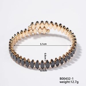 Detail view of a gold diamond-shaped bracelet with black agate inlay and dimensions