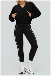 Detail of loose black V-neck hoodie and striped leggings for athletic outdoor wear