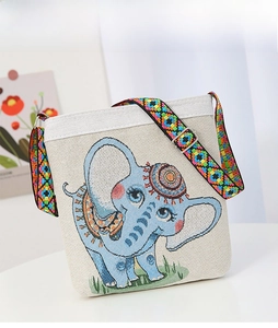 Close-up of elephant embroidery and colorful ethnic crossbody strap on canvas bag