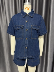 Close-up of dark blue denim set with amber buttons and contrast stitching details