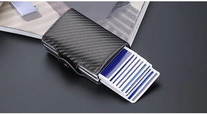 Detail showing carbon fiber RFID pop-up wallet with multiple cards ejected and snap closure
