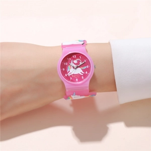 Detailed view of pink unicorn kids watch worn on wrist with colorful silicone strap