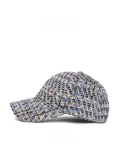 Close-up of the thick textured tweed weave and fiber detail on the side of the baseball cap