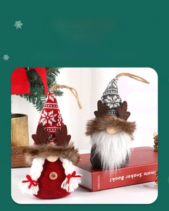 Close-up of handmade Christmas gnome ornaments with knitted hats and faux fur details