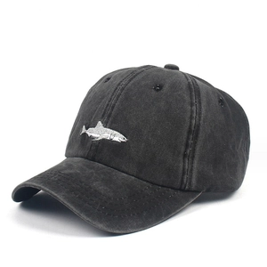 Close-up of the detailed white shark embroidery on a vintage washed cotton baseball cap