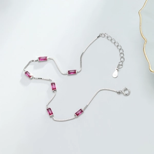 Detail of S925 sterling silver box chain bracelet with rectangular red gemstones