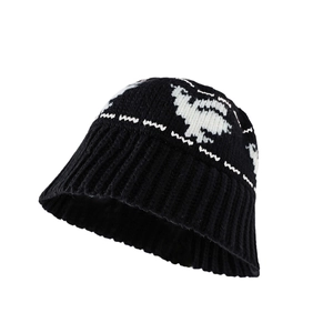 Winter knitted bucket hat in black and white jacquard featuring a dove pattern design