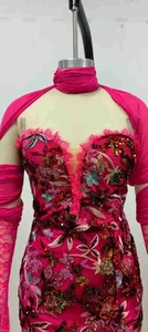 Close-up of fuchsia sequin embroidery and lace details on a strapless evening gown