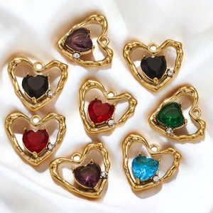 Colorful hollow heart pendants with crystals on elegant white silk background