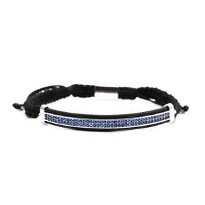 Detail of hand-woven black cord bracelet with blue zircon stones on silver metal bar