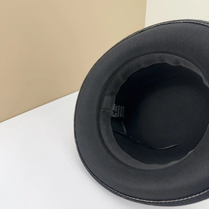 Detail of black wool fedora hat showing inner cotton lining and material wash tag