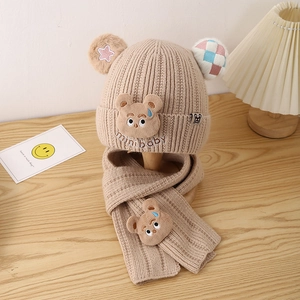 Detail of bear ear knit hat and scarf set for kids with mini baby embroidery in beige