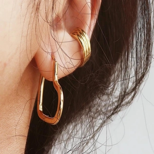 Chic hollow heart pendant earrings and layered gold cuffs for minimalist ear styling