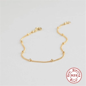 Close-up of gold 925 sterling silver beaded chain bracelet with minimalist dainty design