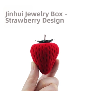 Close-up of red strawberry velvet jewelry box with realistic flocking texture and leaf
