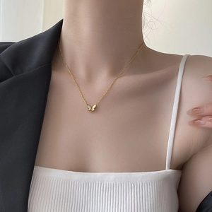 Elegant 18K gold butterfly necklace with white mother of pearl on female model