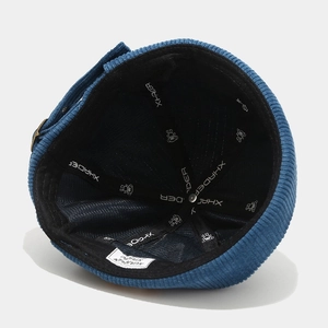 Detailed interior of blue corduroy brimless docker hat showing stitching and lining texture