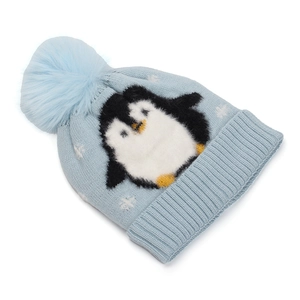 Detail of light blue winter knit hat with penguin pattern and large faux fur pompom
