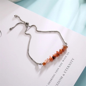Detail of adjustable silver square chain bracelet with orange natural stone chips