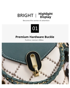 Detail of polished gold hardware lock on white quilted leather bag with green flap