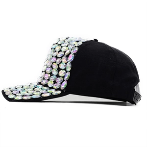 Detail of black baseball cap featuring colorful rhinestones on brim and front crown