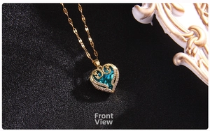 Front view of a gold heart pendant necklace with a blue gemstone and pavé crystals