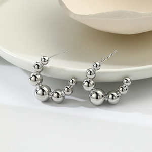 Polished silver C-shaped drop earrings featuring a gradient of metallic hollow beads
