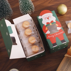Christmas gift box with Merry Christmas typography and cookies on dark wood background