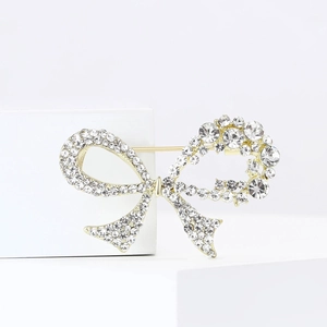 Detailed view of sparkling rhinestones on elegant gold alloy bow brooch for suits
