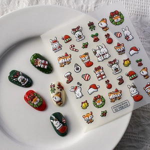 Detail of Christmas 5D embossed nail stickers featuring festive bunny and fox patterns