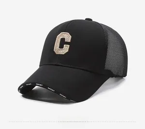 Detail of black mesh baseball cap featuring 3D embroidered C and Sport print
